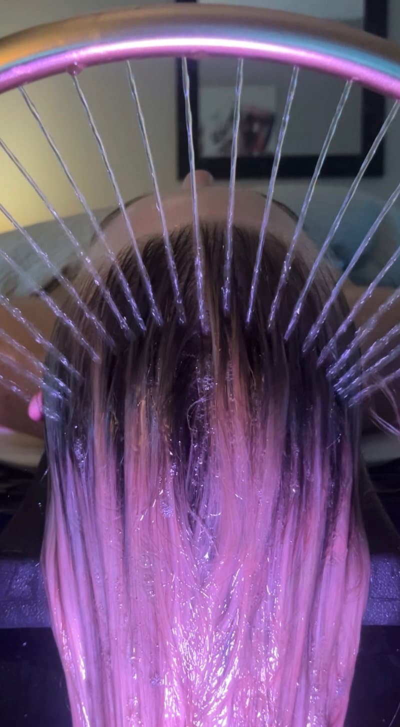 The signature waterfall-ring rinse during a head spa at M-Power Salon & Spa